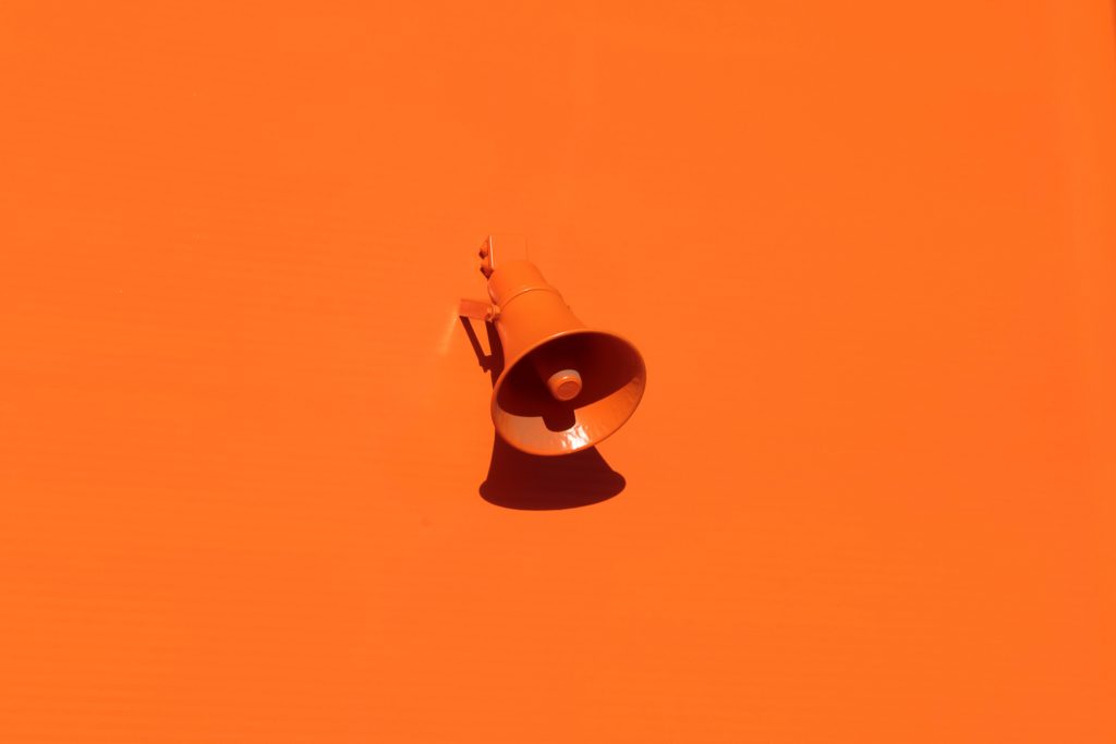 Orange megaphone on orange background