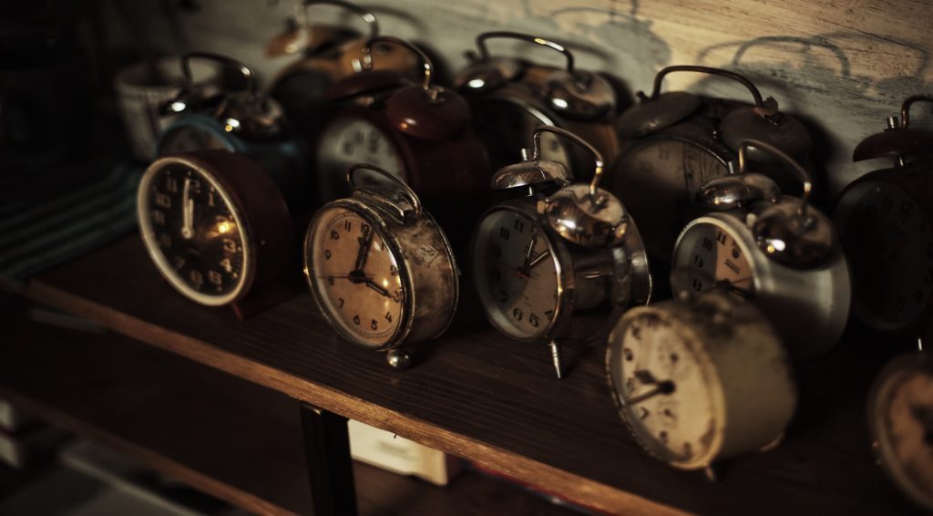 A collection of clocks on a shelf